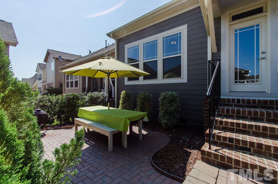 1407 Van Page Boulevard Raleigh, NC 27607 - Photo 21 of 25 a front view of a house with porch and chairs