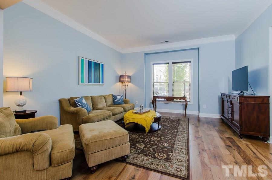 1407 Van Page Boulevard Raleigh, NC 27607 - Photo 5 of 25 a living room with furniture and a flat screen tv