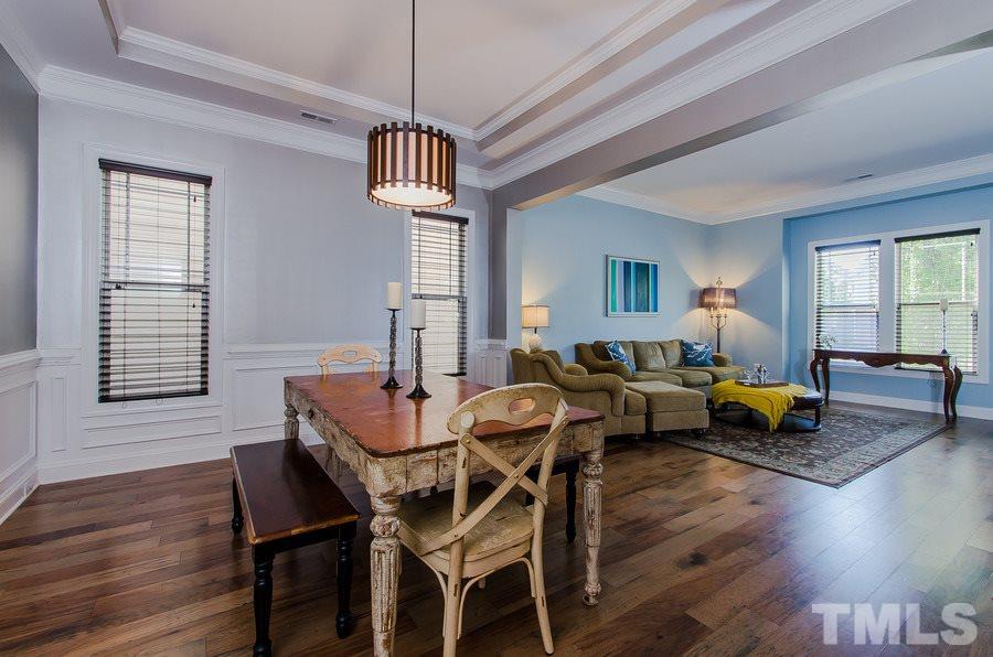 1407 Van Page Boulevard Raleigh, NC 27607 - Photo 7 of 25 a view of a dining room with furniture window and wooden floor