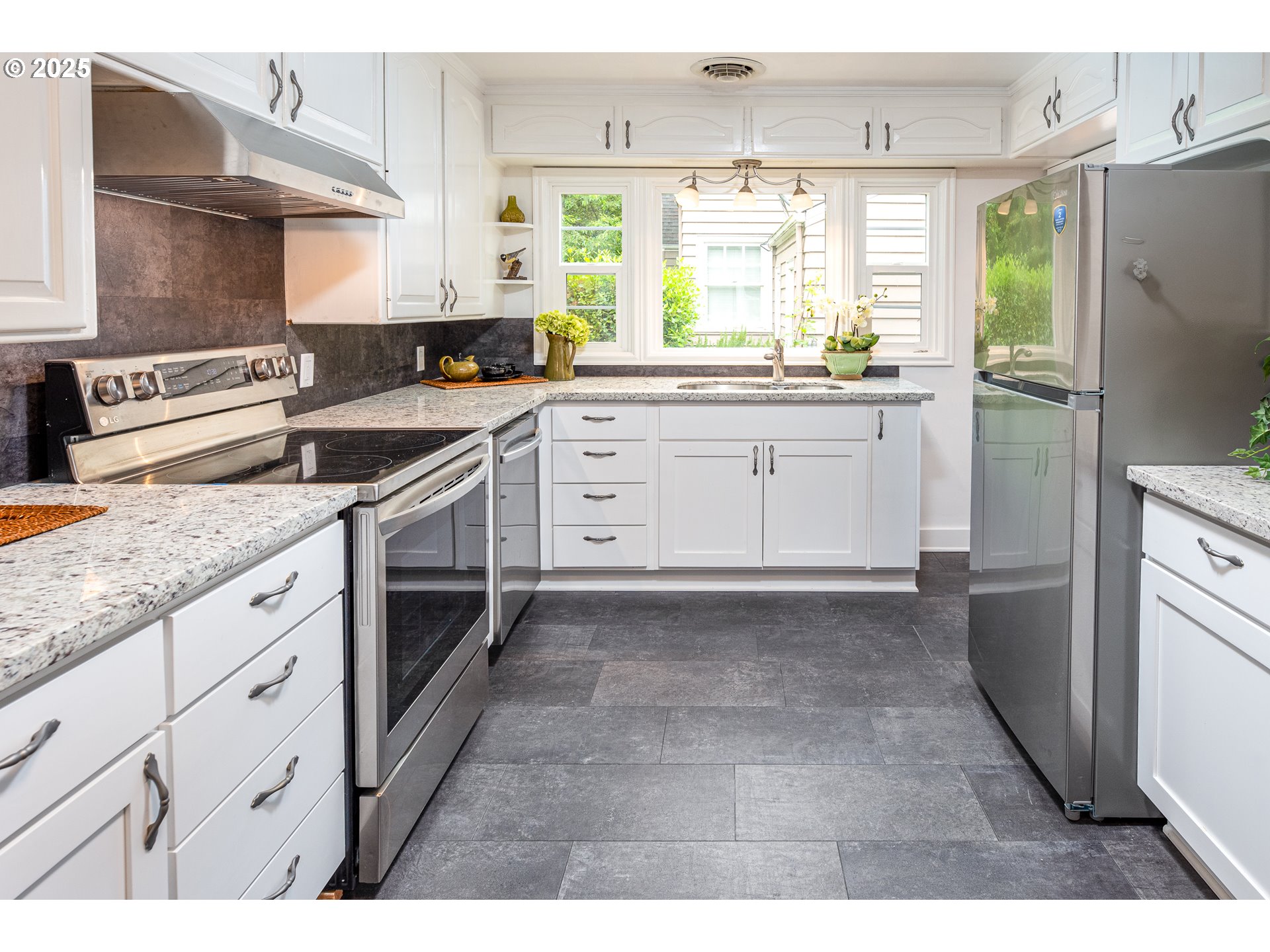 1624 Washington Street Eugene, OR 97401 - Photo 13 of 41 a kitchen with granite countertop a stove a sink dishwasher and a refrigerator