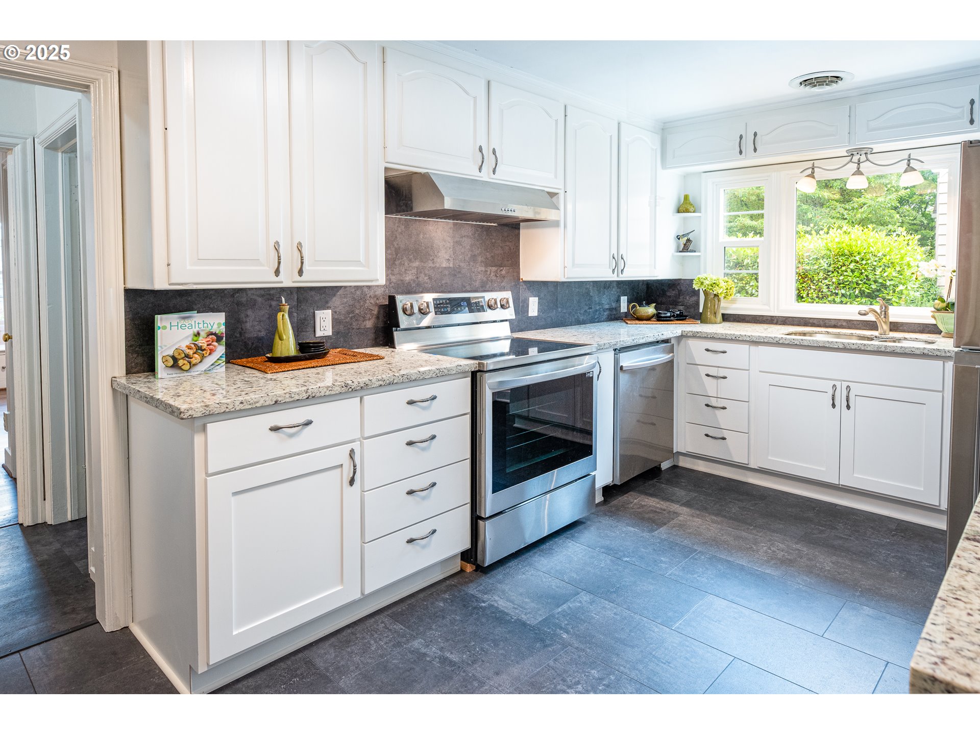1624 Washington Street Eugene, OR 97401 - Photo 14 of 41 a kitchen with cabinets appliances and a window