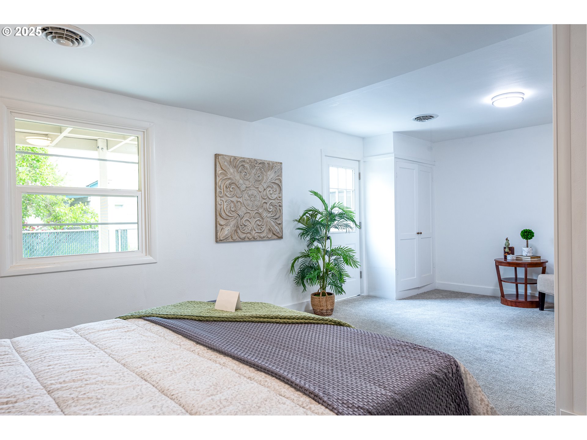 1624 Washington Street Eugene, OR 97401 - Photo 25 of 41 a bedroom with a bed and a potted plant