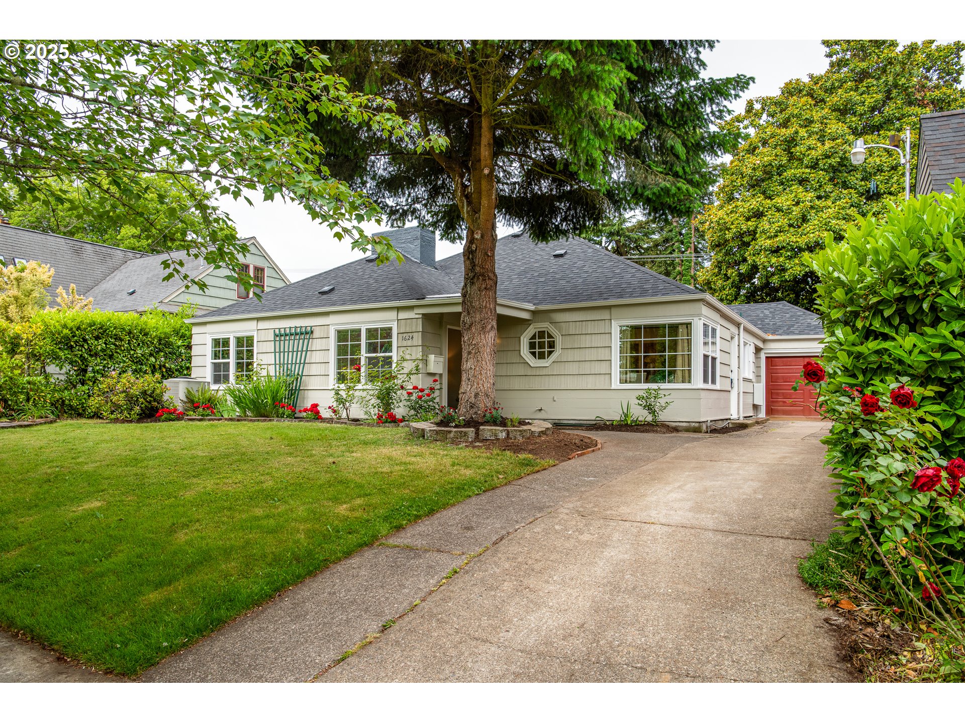 1624 Washington Street Eugene, OR 97401 - Photo 3 of 41 a front view of a house with a garden