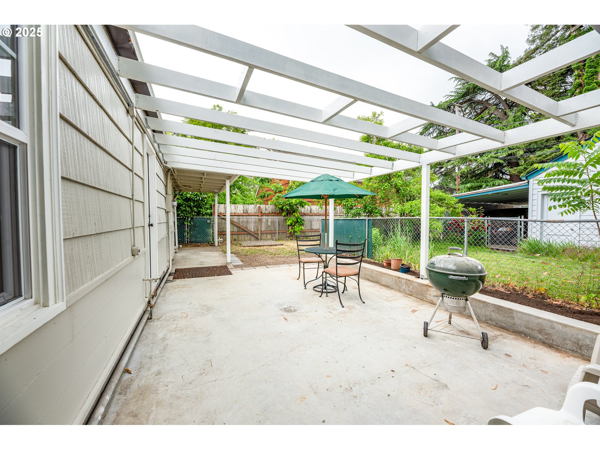 1624 Washington Street Eugene, OR 97401 - Photo 37 of 41 a view of a patio with a table and chairs and potted plants