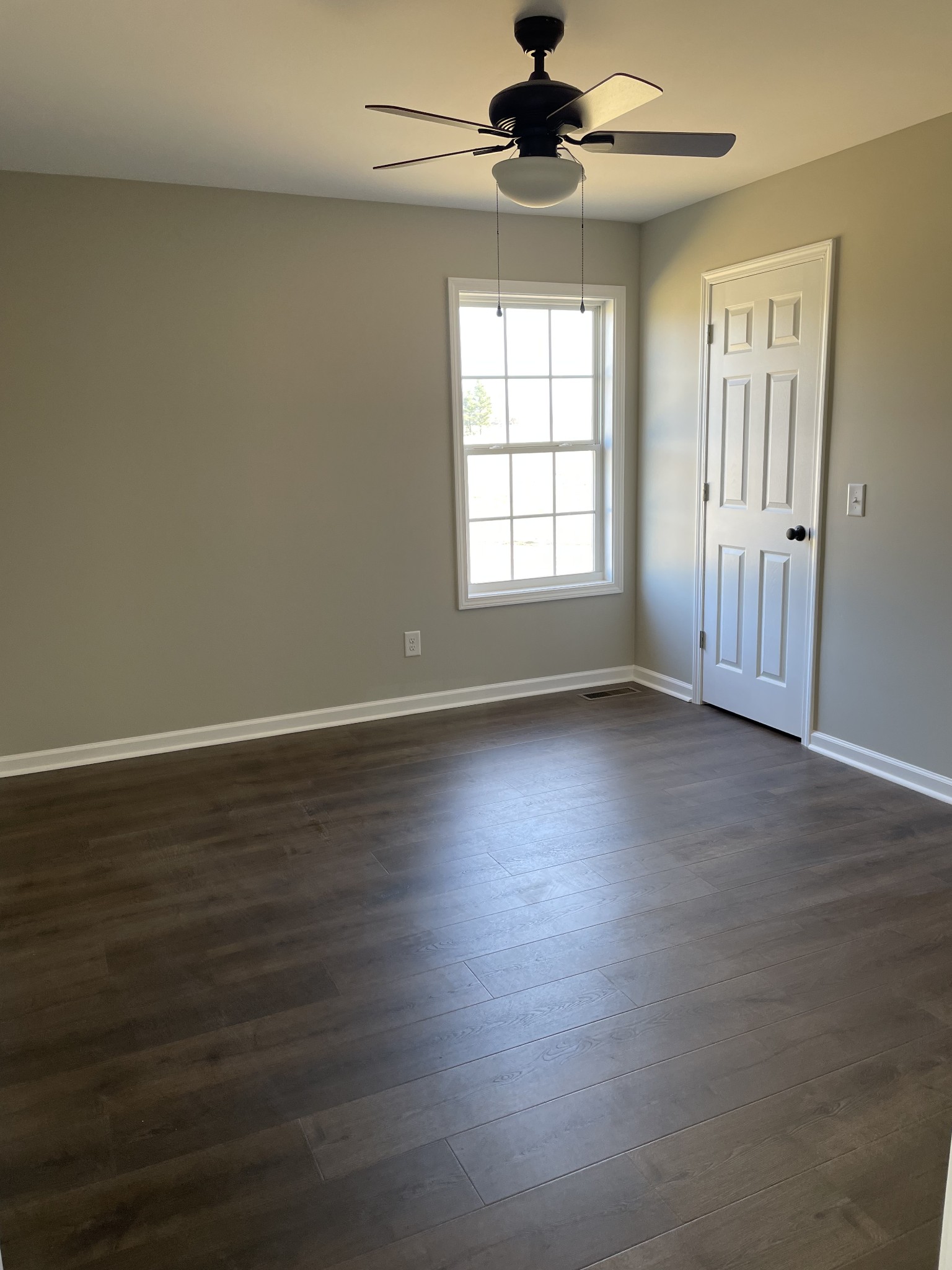 1185 Coleytown Road Lafayette, TN 37083 - Photo 18 of 20 an empty room with wooden floor fan and windows
