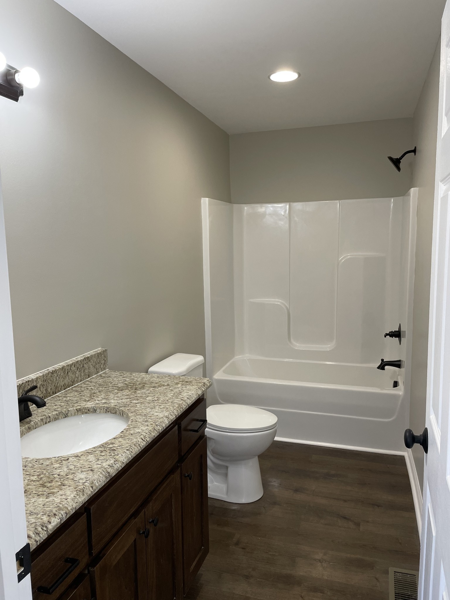 1185 Coleytown Road Lafayette, TN 37083 - Photo 19 of 20 a bathroom with a granite countertop sink toilet and shower