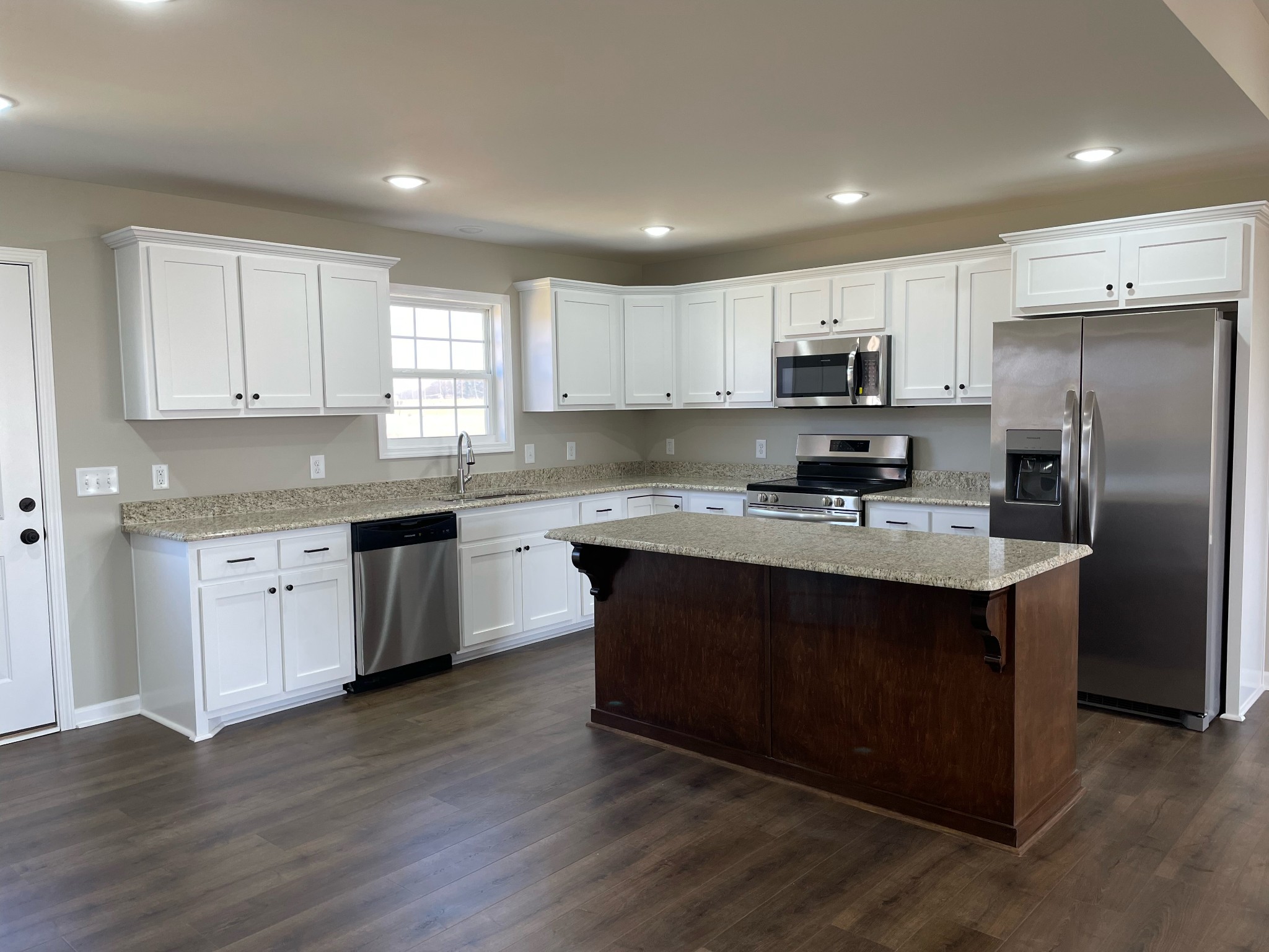 1185 Coleytown Road Lafayette, TN 37083 - Photo 8 of 20 a kitchen with kitchen island granite countertop a sink cabinets and stainless steel appliances