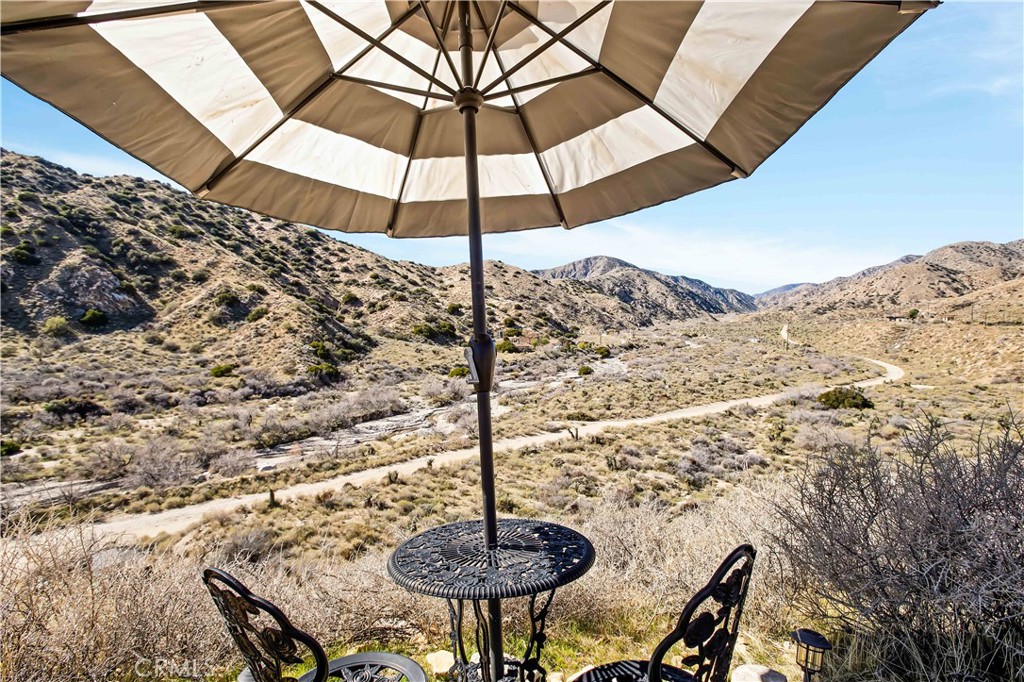 49490 Big Morongo Canyon Road Morongo Valley, CA 92256 - Photo 42 of 75 a table and chairs in a patio