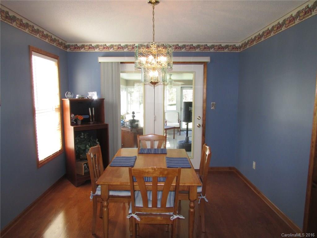 6274 Stokes Ferry Road Salisbury, NC 28146 - Photo 5 of 24 a view of a dining room with furniture a chandelier and wooden floor