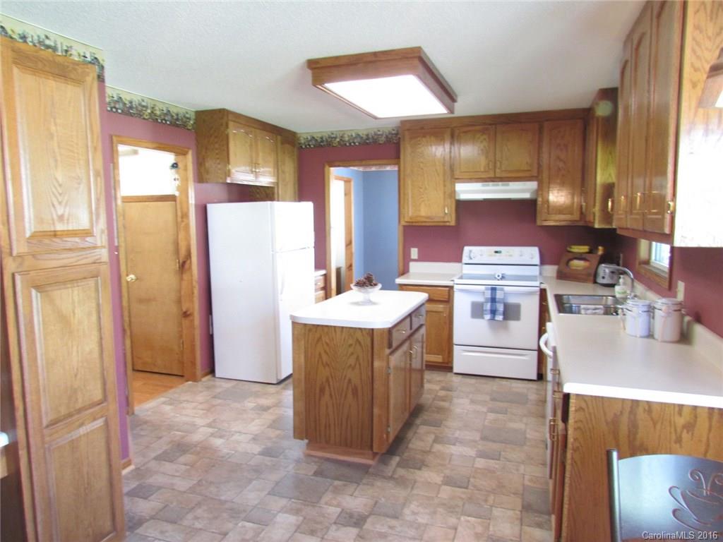 6274 Stokes Ferry Road Salisbury, NC 28146 - Photo 8 of 24 a kitchen with stainless steel appliances a sink a stove a refrigerator cabinets and a window