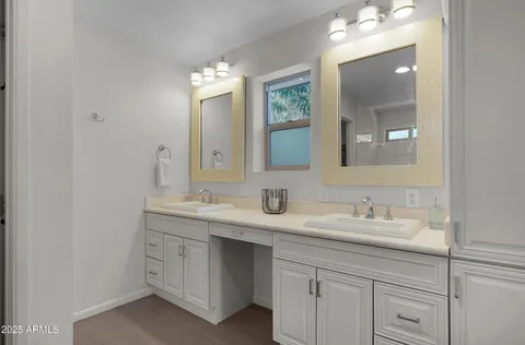 a bathroom with a double vanity sink and a mirror