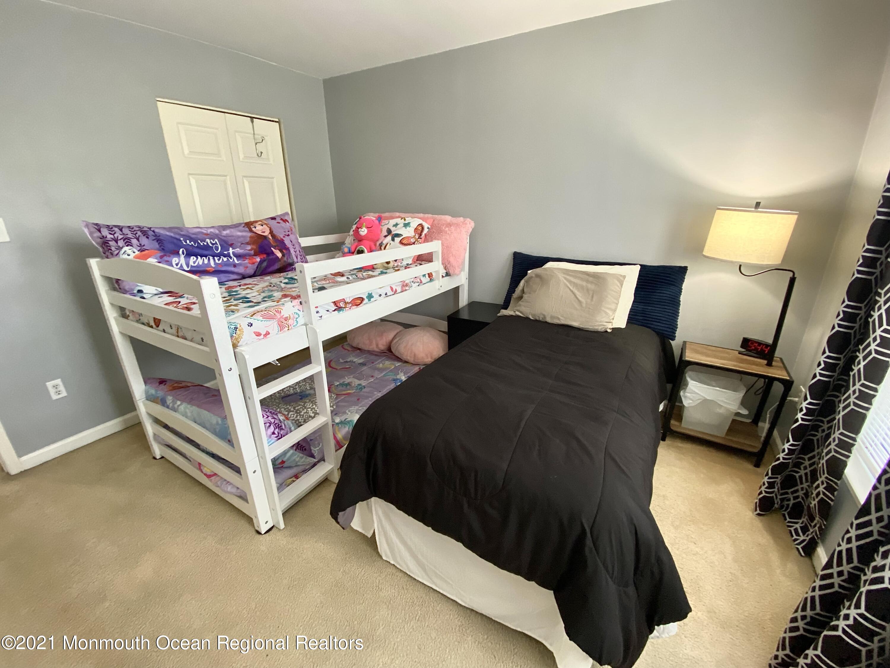 3 Skimmer Lane, Unit 38 Bayville, NJ 08721 - Photo 14 of 22 a bedroom with a bed and a lamp