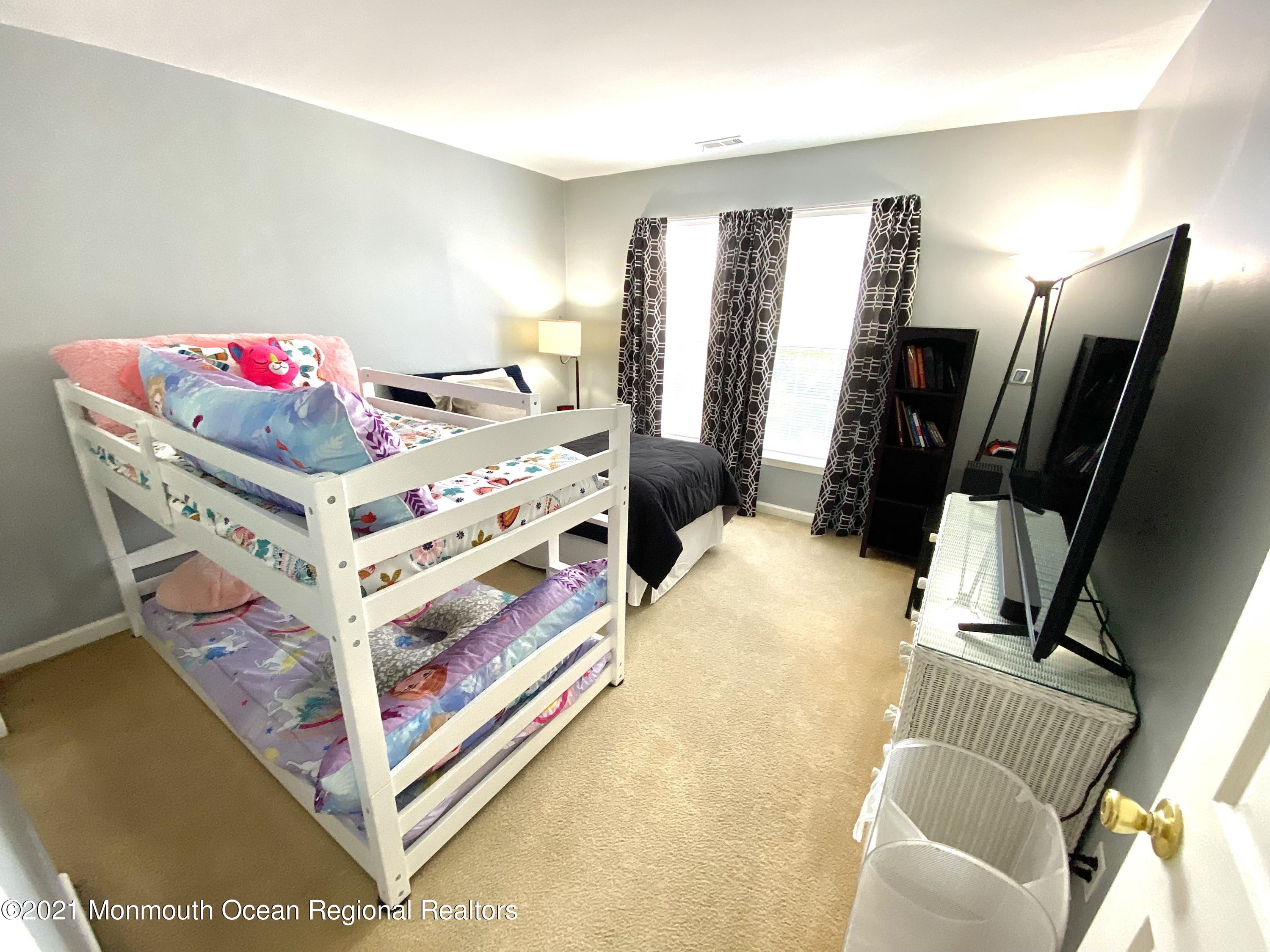 3 Skimmer Lane, Unit 38 Bayville, NJ 08721 - Photo 15 of 22 a bedroom with furniture and a flat screen tv