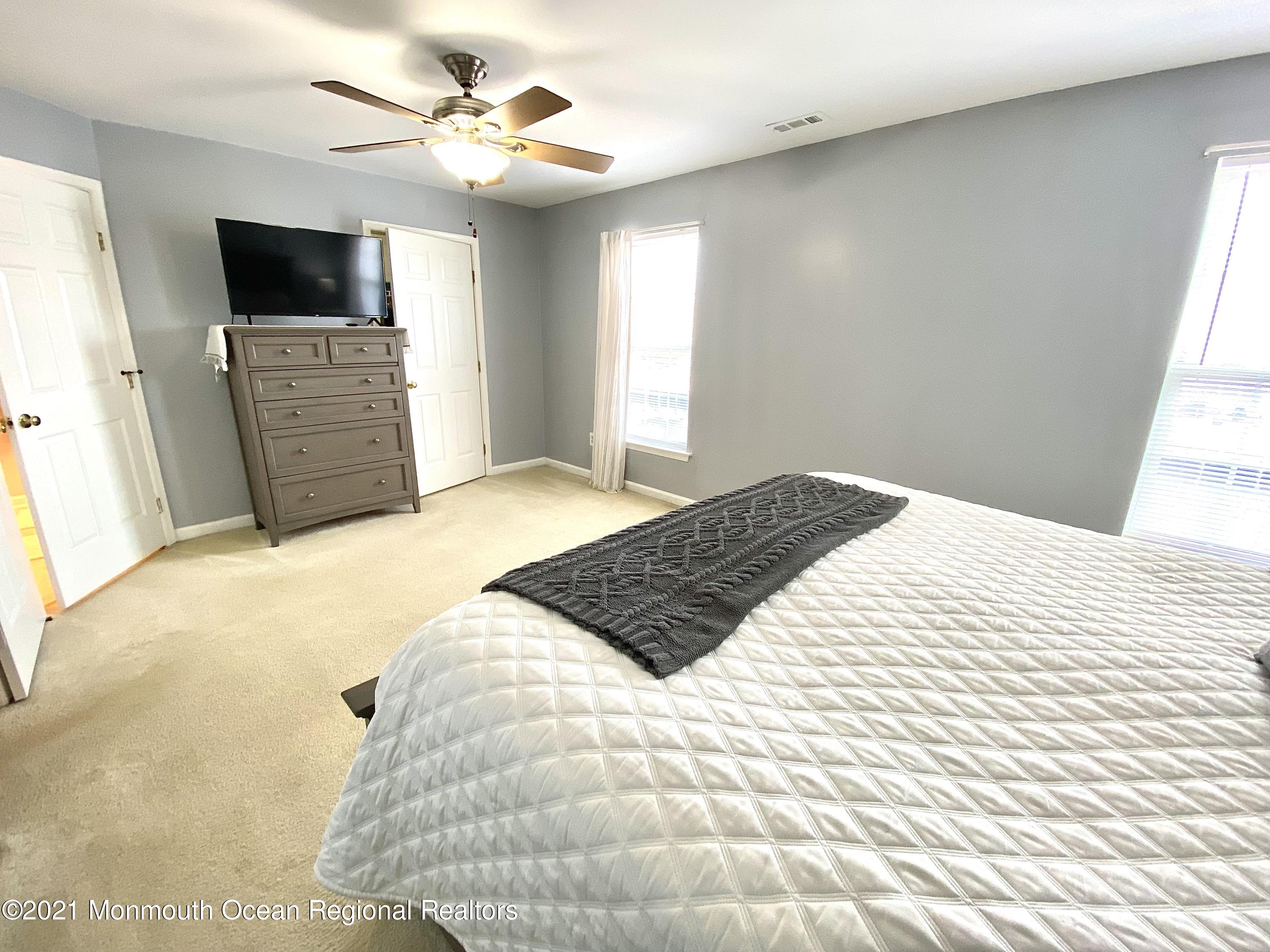 3 Skimmer Lane, Unit 38 Bayville, NJ 08721 - Photo 19 of 22 a bedroom with a bed and a flat screen tv