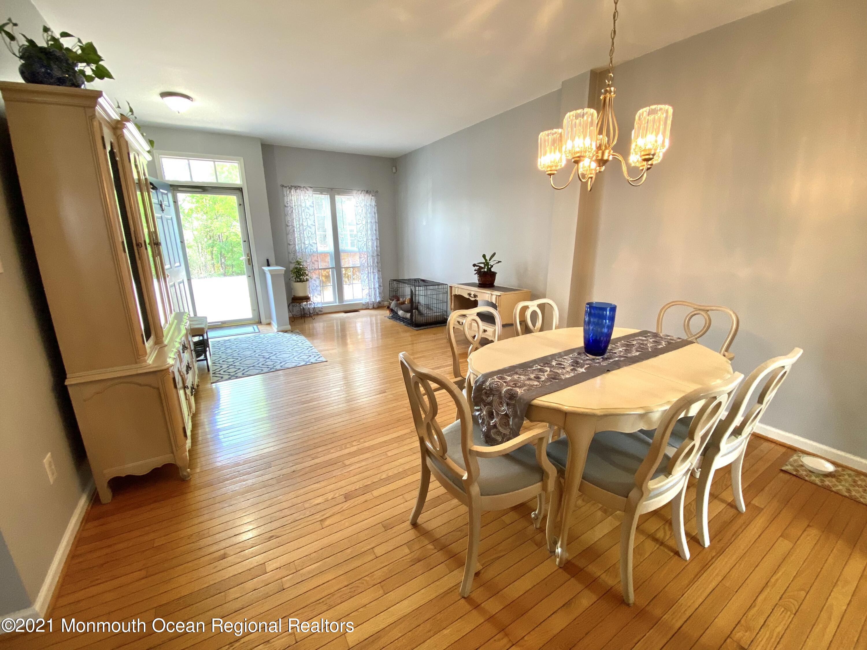 3 Skimmer Lane, Unit 38 Bayville, NJ 08721 - Photo 5 of 22 a view of a dining room with furniture a chandelier and wooden floor