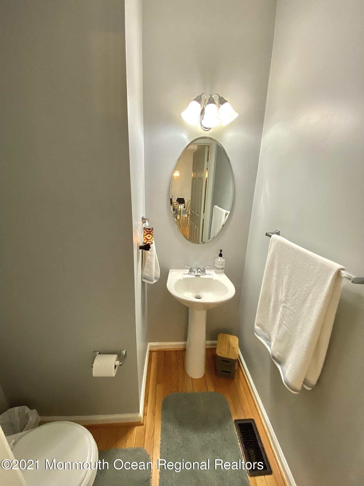 3 Skimmer Lane, Unit 38 Bayville, NJ 08721 - Photo 6 of 22 a bathroom with a sink a toilet and a mirror