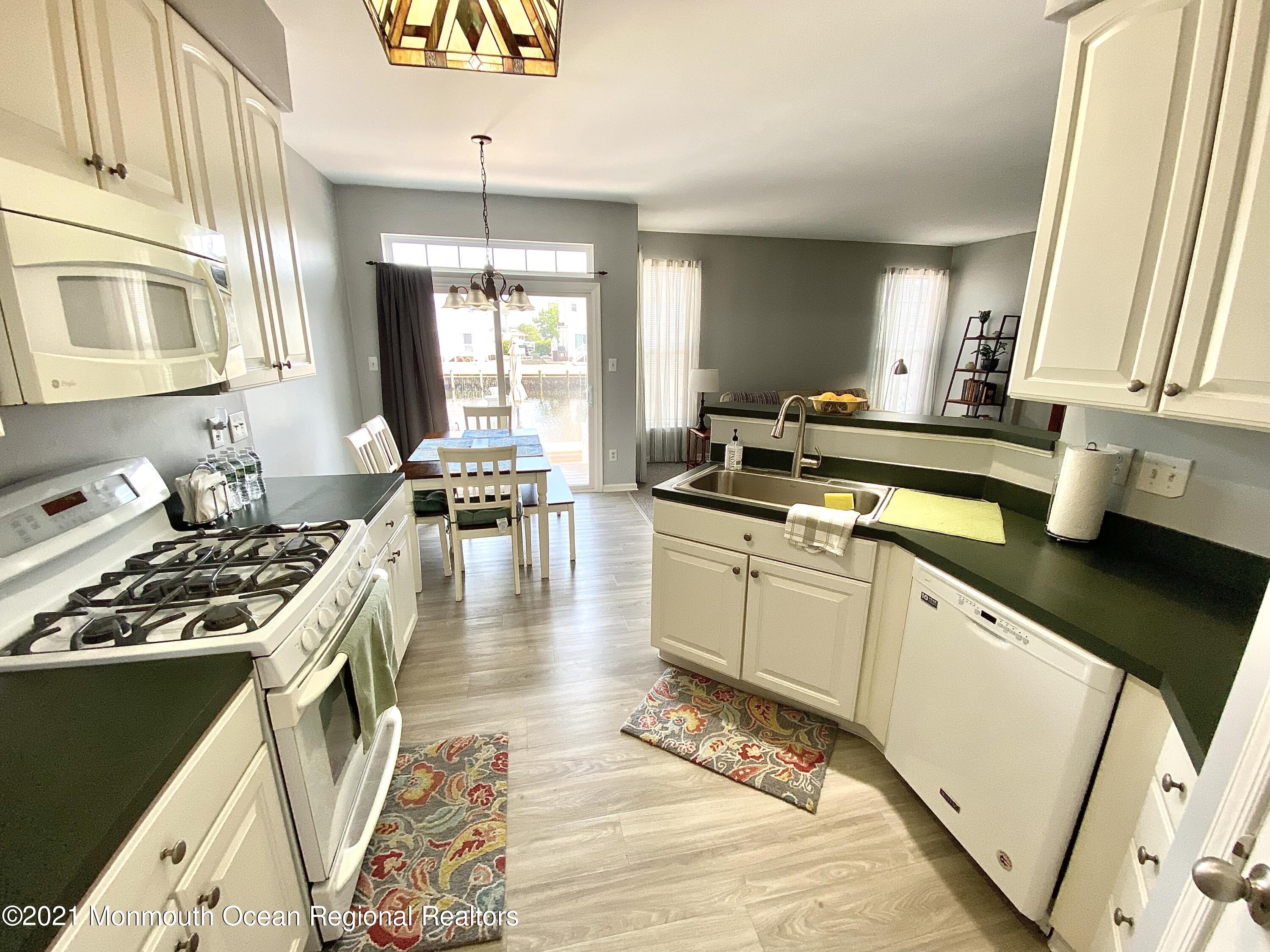 3 Skimmer Lane, Unit 38 Bayville, NJ 08721 - Photo 7 of 22 a kitchen with a stove a sink and a refrigerator