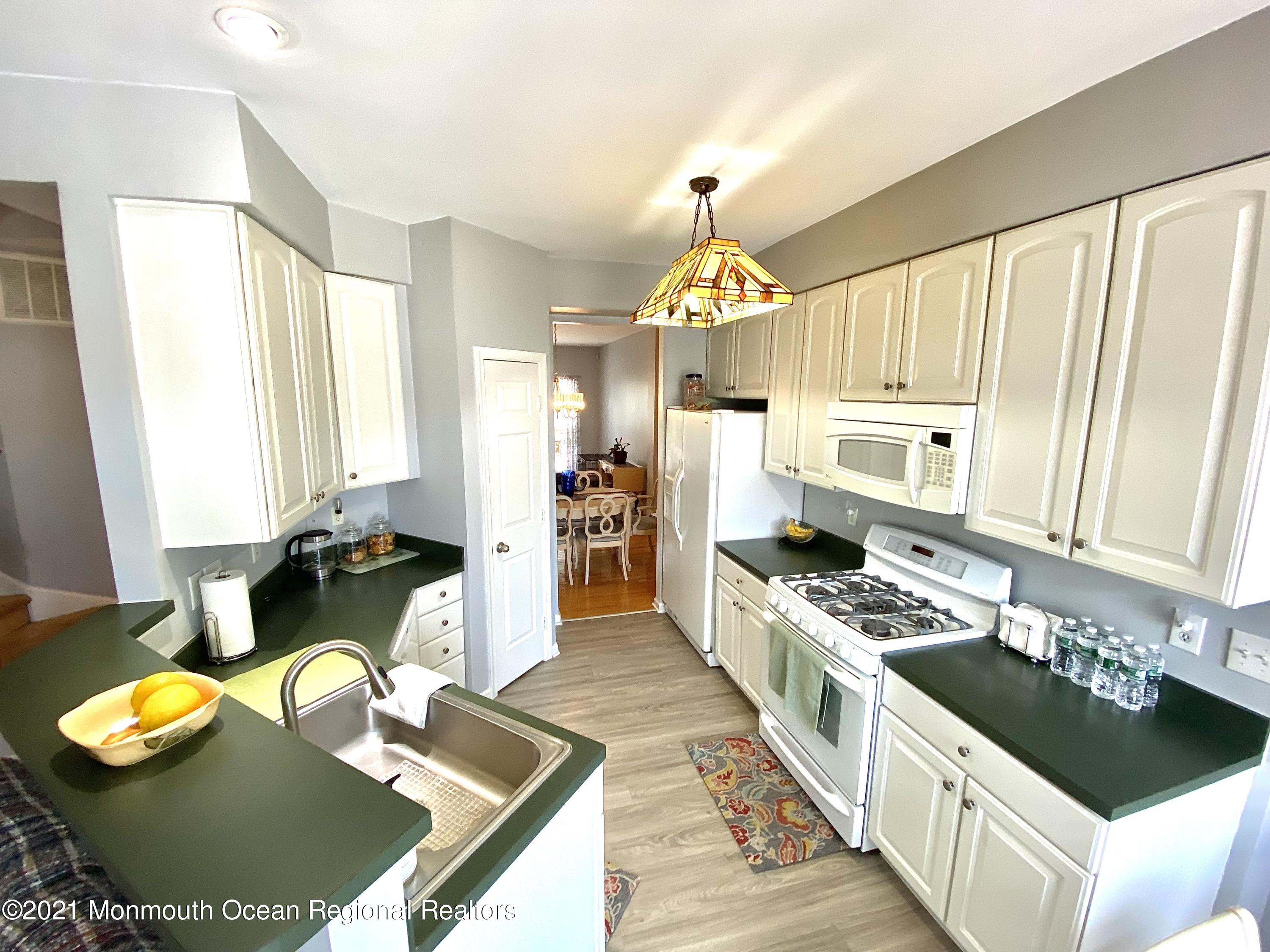 3 Skimmer Lane, Unit 38 Bayville, NJ 08721 - Photo 8 of 22 a kitchen with stainless steel appliances granite countertop a stove and a wooden cabinets