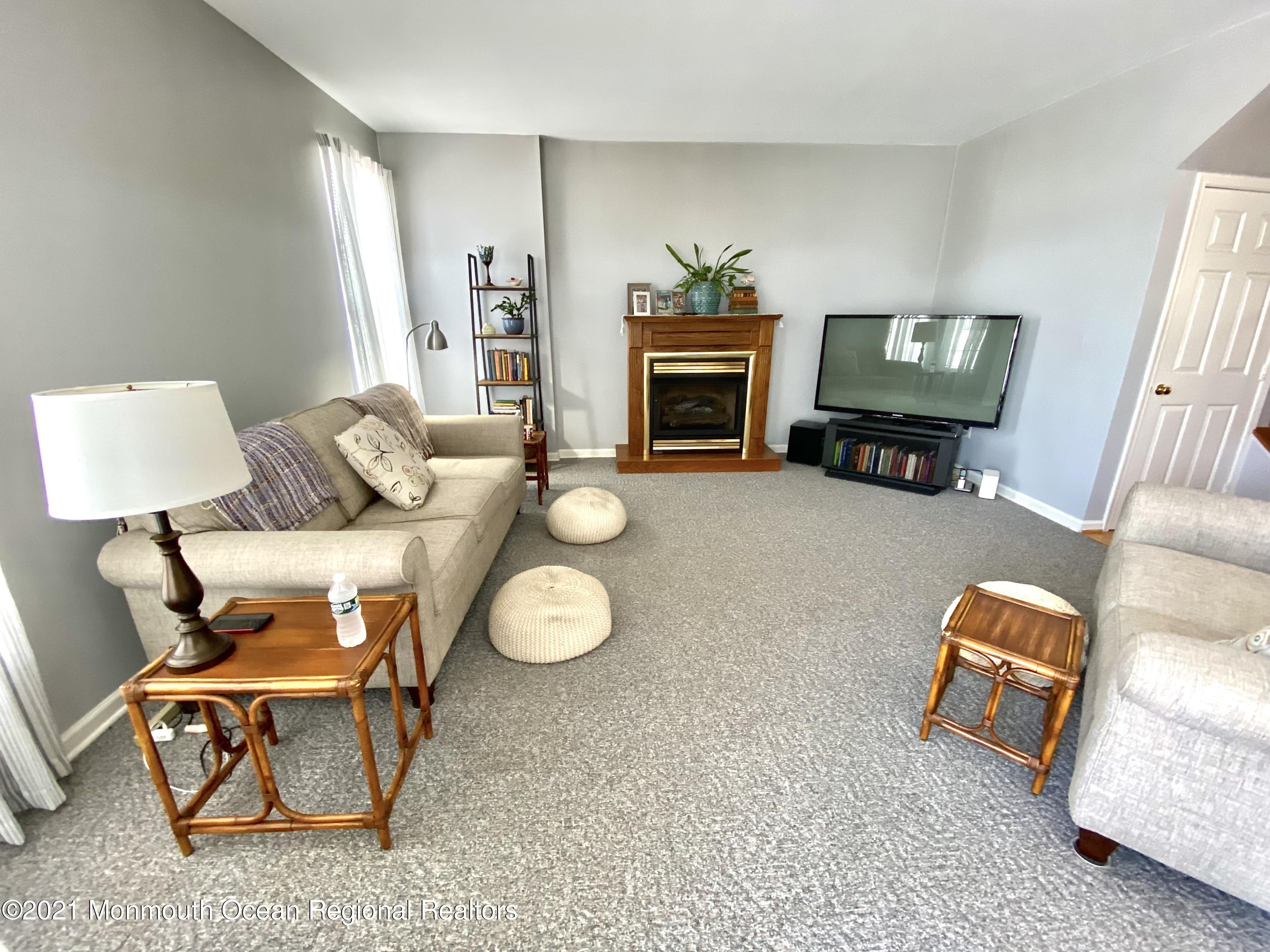 3 Skimmer Lane, Unit 38 Bayville, NJ 08721 - Photo 9 of 22 a living room with furniture and a fireplace