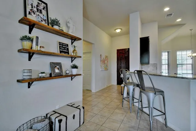 a kitchen with stainless steel appliances granite countertop a sink and a refrigerator