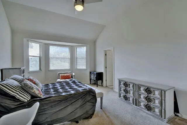 a bedroom with a bed and a lamp