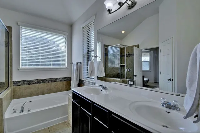 a bathroom with a bathtub and a shower