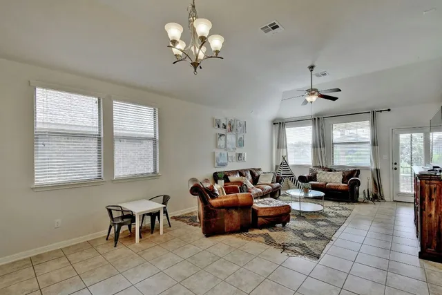 a living room with furniture flowerpot and window