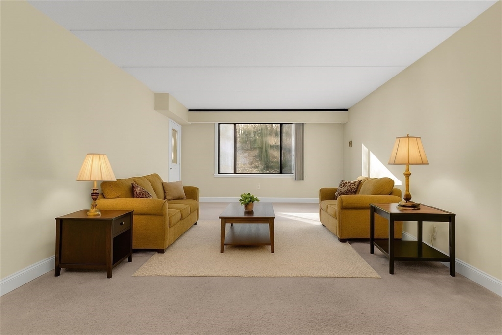 1500 Worcester Road, Unit 221 Framingham, MA 01702 - Photo 5 of 34 a living room with furniture and a lamp