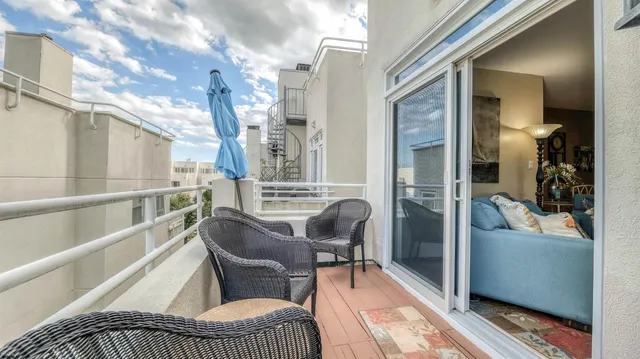 a balcony with furniture and a potted plant