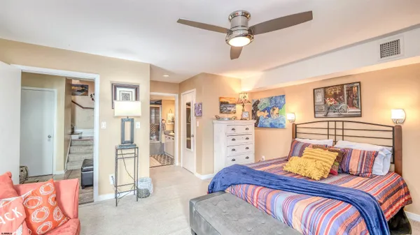 a bedroom with a bed closet and flat screen tv