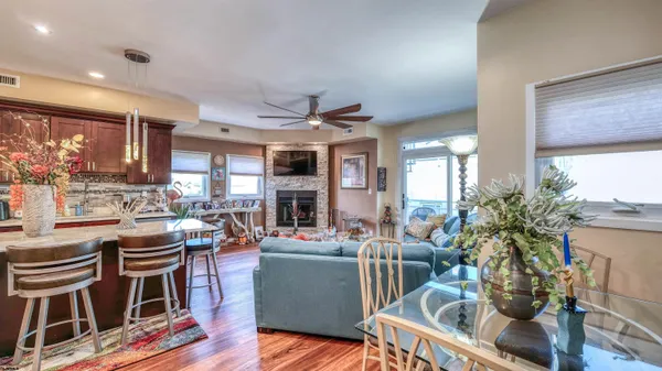 a living room with fireplace furniture and a large window