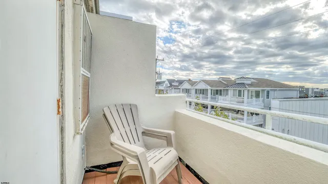 a view of a balcony with chair and table