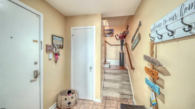 a view of a hallway with wooden floor and stairs