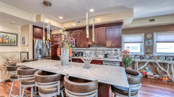 a kitchen with granite countertop lots of counter top space a sink a window and stainless steel appliances