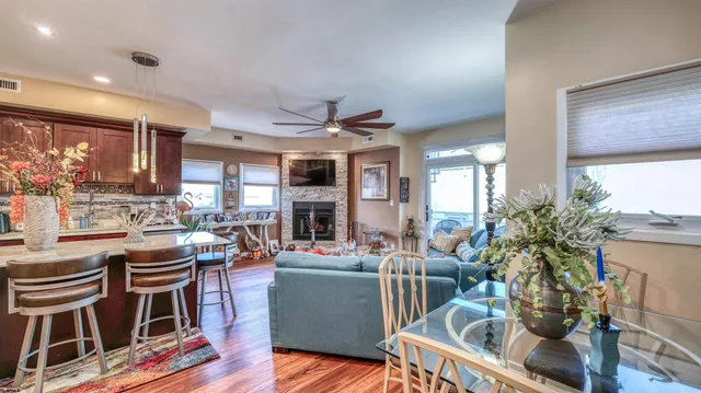 a living room with fireplace furniture and a large window