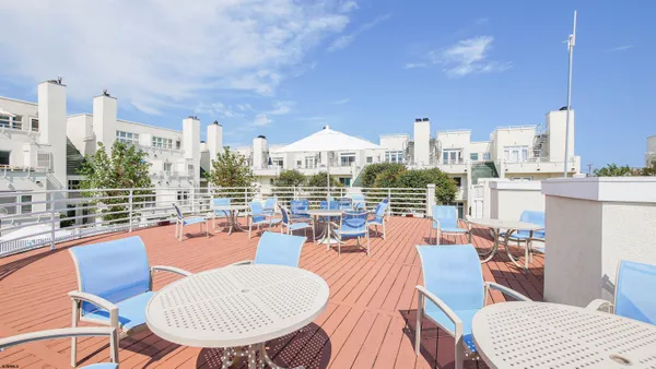 a view of a balcony with table and chairs