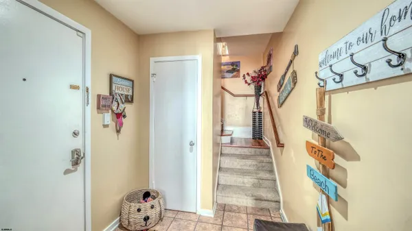 a view of a hallway with wooden floor and stairs