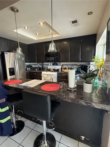 a kitchen with a sink a counter and chairs