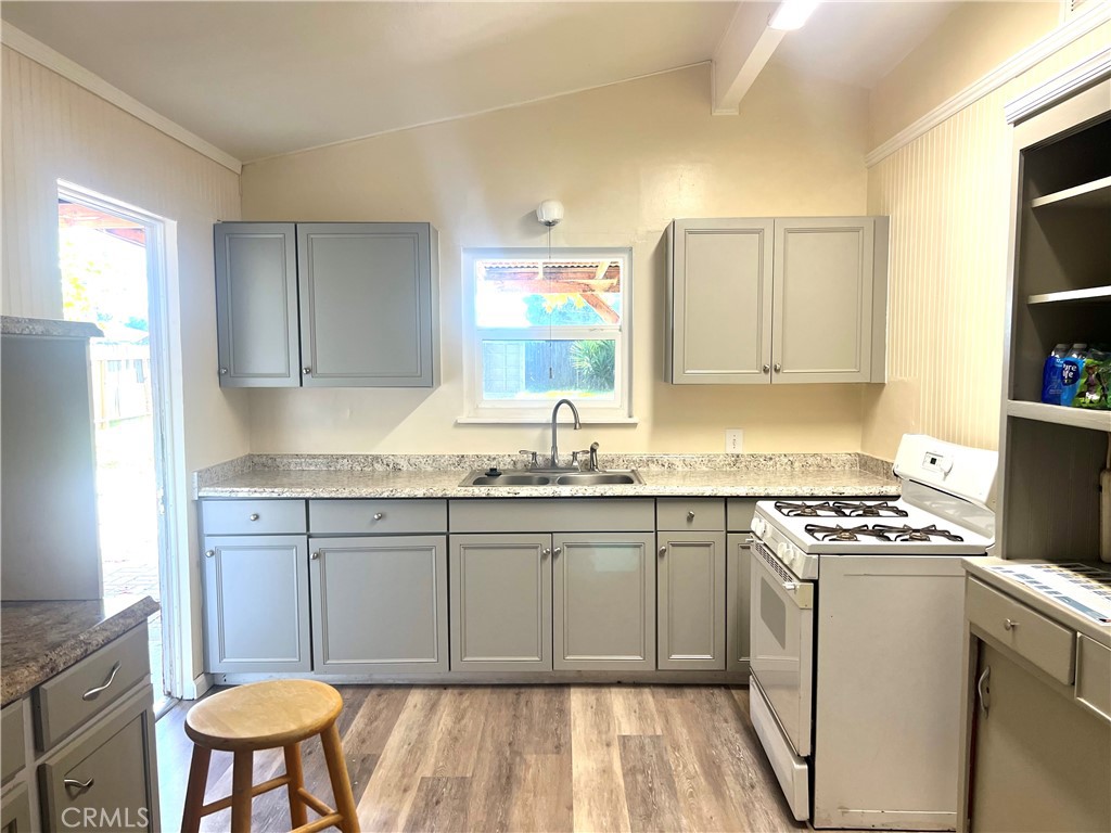 1550 Primrose Avenue Merced, CA 95340 - Photo 14 of 46 a kitchen with granite countertop a sink cabinets and stainless steel appliances