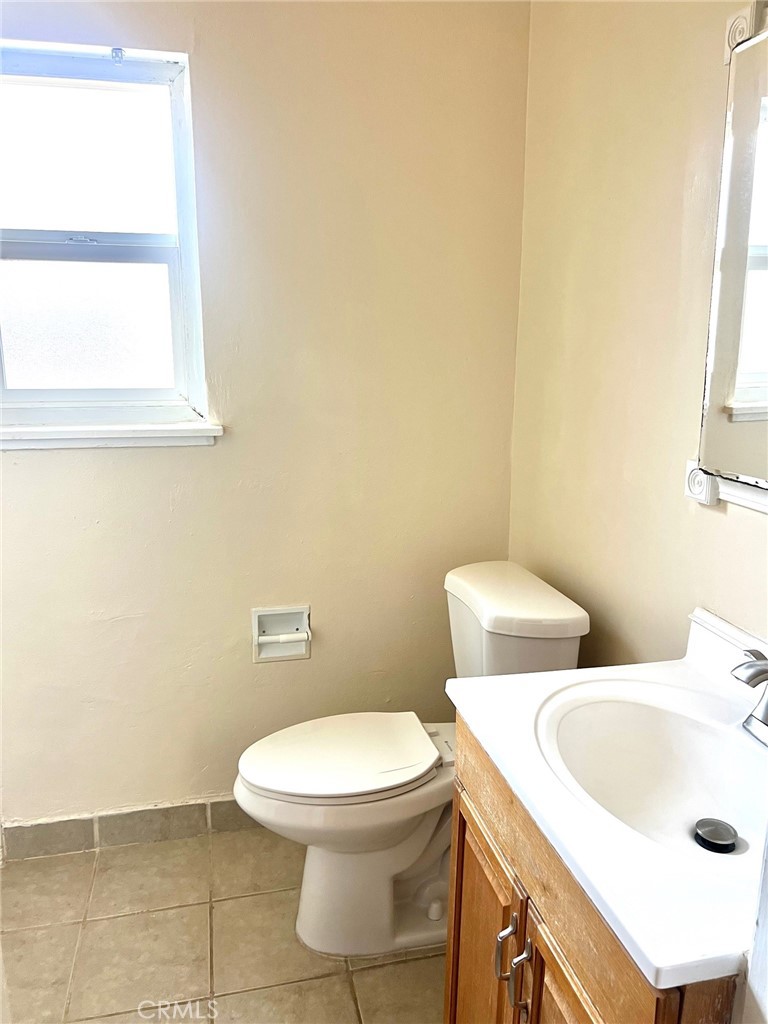 1550 Primrose Avenue Merced, CA 95340 - Photo 27 of 46 a white toilet sitting next to a bathroom sink