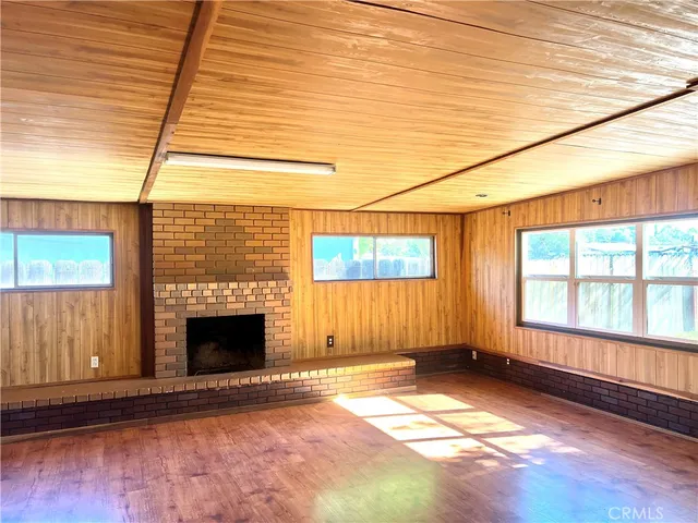 a view of a backyard with plants and wooden fence
