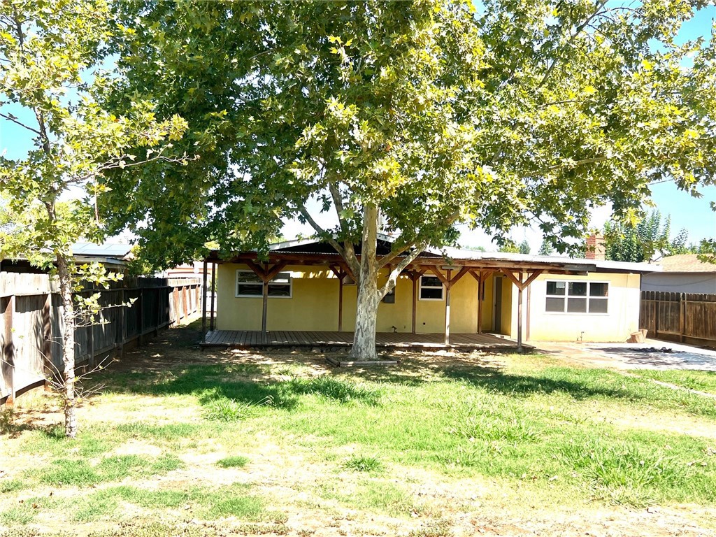 1550 Primrose Avenue Merced, CA 95340 - Photo 34 of 46 a front view of house with yard and trees in the background