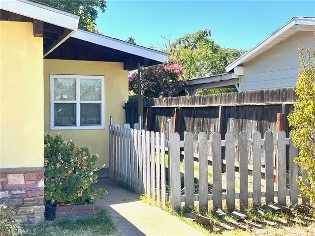a view of a room with a ceiling fan and bathroom