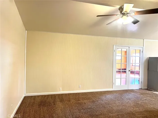 a view of a kitchen with a refrigerator and a chandelier fan
