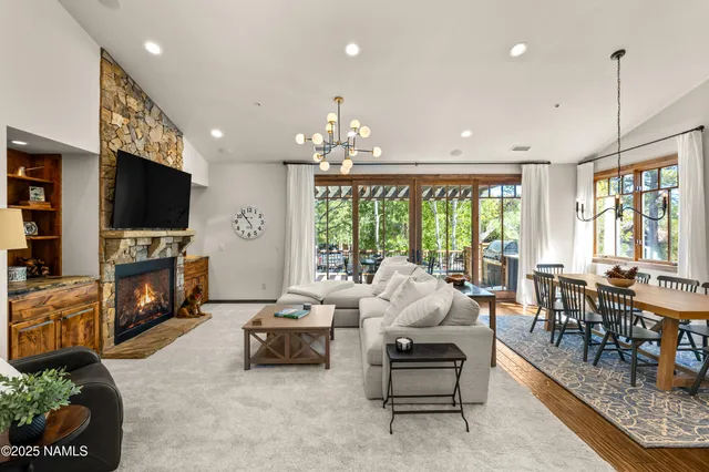 a living room with fireplace furniture and a flat screen tv
