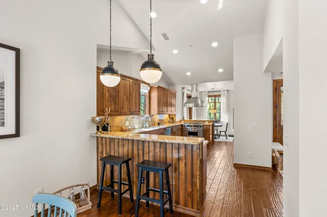 a kitchen with stainless steel appliances granite countertop a stove sink and cabinets
