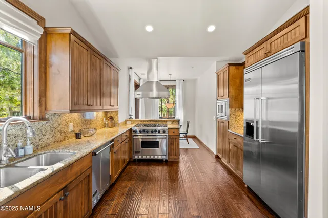 a kitchen with stainless steel appliances a stove and a refrigerator