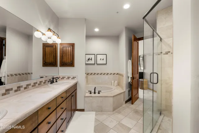 a bathroom with a bath tub and shower