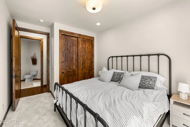a bathroom with a sink vanity mirror and toilet