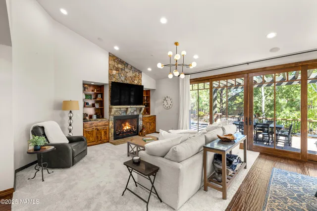 a living room with furniture a fireplace and a flat screen tv